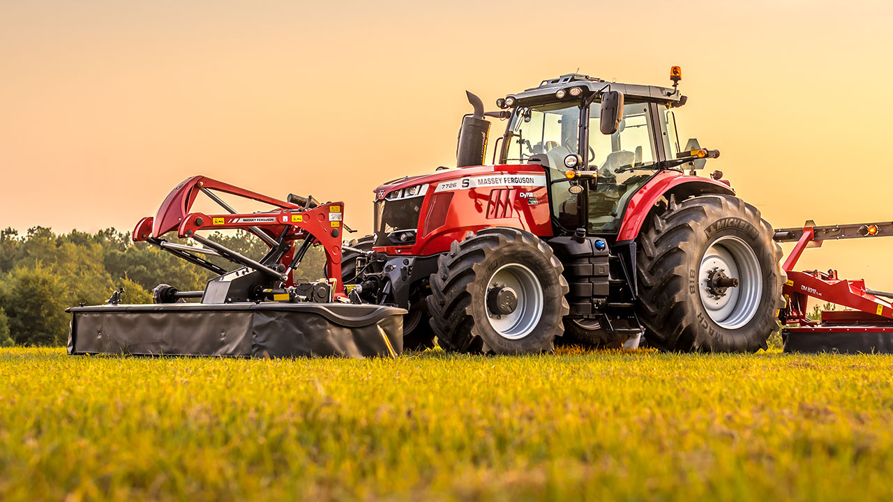 Massey Ferguson tractor and DM Series triple mower in a field of grass